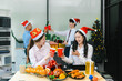 © NINENII - Asian people, celebrating together and gift exchange at Merry Christmas & Happy New Year. excited businessman feel happy work complete and celebration successful deal.