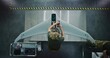 © Framestock - Woman in Camouflage Uniform Working on Next Generation Drone. Female Soldier Installing Electronic Parts Into Surveillance Drone. Concept of Advanced Military Research and Development. Top View.