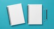 © Okla studio - Notebooks and Pencils:  A crisp, overhead shot showcases two spiral-bound notebooks and a couple of sharpened pencils on a teal background. An invitation to ideas and creative thoughts.