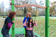 © Alessandro Grandini - Family enjoying playful swing time in autumn park