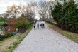 © Alessandro Grandini - Family walking gravel path bridge during autumn season