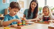 © Flatart - Preschooler building tower with blocks, while two kids learn with teacher in the classroom setting. Preschool teacher helping children in a learning environment.