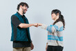 © IHERPHOTO - Smiling couple bumping fists, isolated. Attractive couple smiling and bumping fists