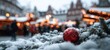 © Gurav - The red Christmas ornament on snowy fir branch at a festive market with bokeh lights