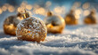 © thodonal - Golden christmas ornaments resting on snow with bokeh effect