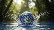 © yevhen89 - Earth globe splashing into clear water in a lush green forest on a bright sunny day