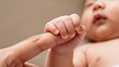 © Qing - Baby's hand grasping adult's finger, symbol of love and connection