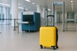 © The Little Hut - Yellow Suitcase at Airport Security Checkpoint with Scanner and Metal Detector in Terminal Waiting Area