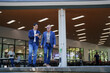 © MINAE - Businessmen discussing information on smartphone while walking