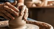 © antuanetto - Hands adjusting wet clay on a spinning pottery wheel in a warm studio for a handmade craft concept and artistic creation