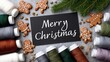 © pvl0707 - Decorative display of gingerbread cookies and sewing threads with Merry Christmas message for holiday crafting activity