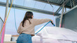 © ADDICTIVE STOCK - Woman using pressure washer at an outdoor car wash
