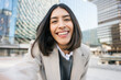 © Franci Leoncio - Young woman smiling while taking a selfie in city