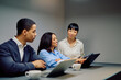 © we.bond.creations - Diverse business professionals having a meeting, discussing strategy while looking at a laptop and using a digital tablet