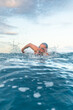 © ADDICTIVE STOCK - Man swimming in the Mediterranean sea under clear sky