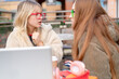 © Iryna - Two friends sharing a serious conversation at an outdoor cafe during the afternoon