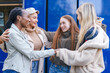 © Iryna - Friends enjoying a joyful moment together outside in the city on a sunny day