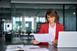 © Stock 4 You - Focused business woman saleswoman working on laptop computer reading analysing financial loan contract document in office. Mature manager businesswoman specialist doing paperwork using pc. Copy space