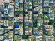 © AmazingAerialAgency - Aerial view of densely packed buildings with rooftops covered in greenery, creating a textured urban landscape from above, Dhaka, Dhaka Division, Bangladesh.