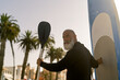 © Guillermo Spelucin - Mature man enjoying paddle surf on beach