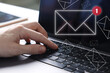 © New Africa - New email notification. Man using laptop, closeup. Letters flying out of screen