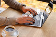 © New Africa - Man sending or receiving email on laptop at table, closeup. Letters flying out of screen