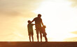© kieferpix - Father and Children Silhouette at Sunset