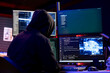 © DC Studio - Hooded hacker coding on PC, using AI to evade security with stealth malware. Evil man using artificial intelligence script on computer to hide malicious code from detection systems