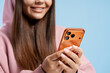 © Maria Vitkovska - Young woman smiling, texting on smartphone, engaging in digital communication