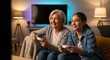 © Bouchra Visuals - Grandparent and teen playing cooperative video game in cozy living room