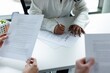 © Oleksii Syrotkin/Stocksy - Agent signature purchase agreement while couple clients read document