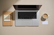 © Marc Tran/Stocksy - A modern workspace setup featuring a laptop, coffee, and notes