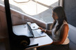 © Rob and Julia Campbell/Stocksy - A focused professional working on a laptop in a modern meeting pod