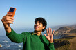 © Ivan Jovanovic/Stocksy - Excited man captures selfies on Pacific coast