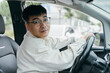 © ZQZ Studio/Stocksy - Asian man hands on steering wheel