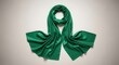 © Ariestia - Smooth emerald fabric accessory is elegantly draped across a light neutral surface