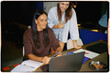 © Adrian Rodd/Stocksy - Analog shot of two female colleagues working together