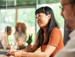 © Aleksandra Jankovic/Stocksy - Portrait of Professional Asian Woman During Group Meeting