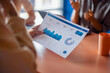 © OchreOchre/Stocksy - Team Meeting Analyzing Data Dashboard Report With Charts