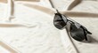 © Ariestia - Black aviator style optical accessories rest on soft draped fabric