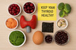 © Chanita - Thyroid gland health and nutrition concept with model and iodine rich food for healthy diet and wellness. An educational message on sticky note for endocrine system care