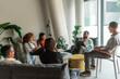 © Aleksandra Jankovic/Stocksy - Diverse Team in Modern Office Lounge Having Relaxed Business Meeting