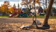 © Niat - Empty swing set at autumn playground.