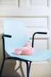 © AUDSHULE/Stocksy - Pink balloon on blue chair