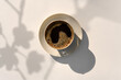 © Tatyana Lavrova/Stocksy - Black Coffee with Foam in a Ceramic Cup and Saucer under Sunlight.