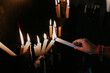 © VICTOR TORRES/Stocksy - Candle lighting in ancient church