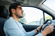 © mahalo studio/Stocksy - Man driving car in daylight