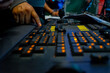 © NAILOTL MENDEZ/Stocksy - Lighting engineer hand operating control console at event