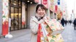 © Yka - 初売りで買った福袋を見せて喜ぶ日本人女性
