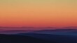 © ArtWorld - Layered mountain ranges silhouetted against a vibrant orange and pink sunset sky mountains landscape